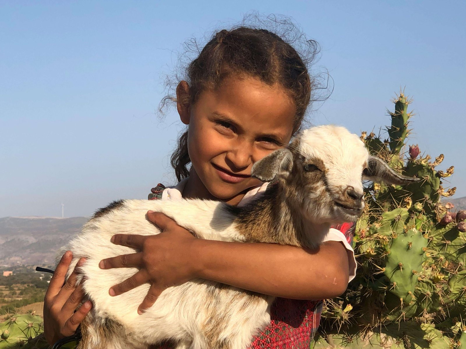 Child-Embracing-Goat-in-Moroccan-Countryside.jpg